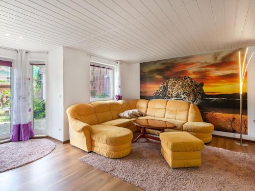 a living room with a couch and a painting at Ruhige Gartenwohnung in Dresden in Dresden