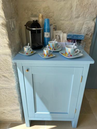 a blue cabinet with cups and saucers on it at Trullo Nadia Ostuni in Ostuni