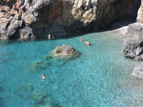 a group of people swimming in a body of water at La dimora di Radha B&B Centro Olistico in Rende