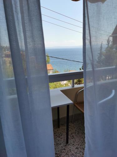 a view of the ocean from a room with a window at Hotel Rania in Loutra Edipsou