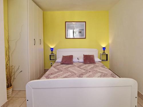 una camera con un letto bianco con due cuscini di Apartment Devcic a Šilo