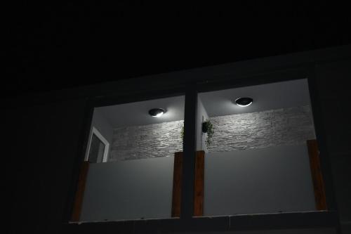 a glass door with two lights in a room at WooW Apartments in Velika Gorica