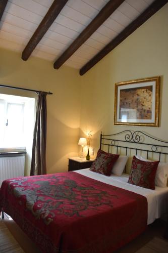 a bedroom with a large bed with a red blanket at The Merchants House in Perítheia
