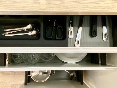 a drawer with utensils in a cabinet at Suite Breeze - Private Heated Pool in Málaga