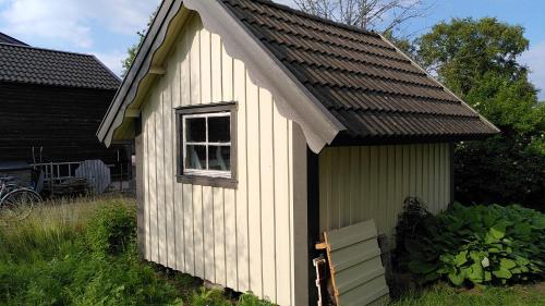 a small shed with a window and a roof at Lilla mysstuga i havsnära in Varberg