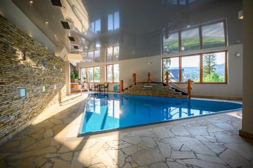 a large room with a swimming pool in a building at Viva Maria Apartamenty in Zakopane