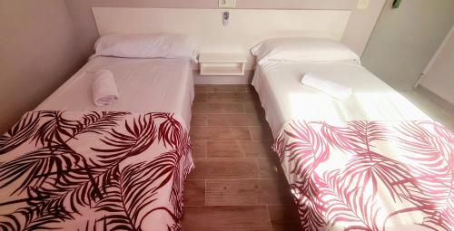 two beds sitting next to each other in a room at Hostal La Cabaña in Salou