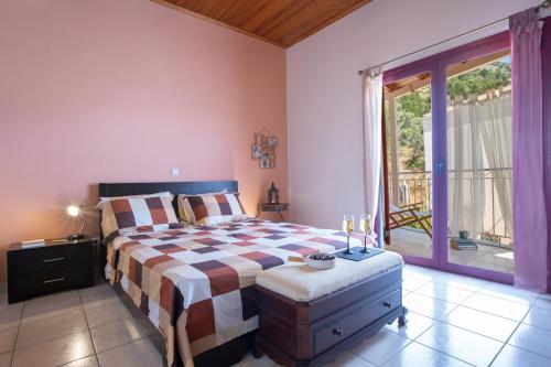 a bedroom with a large bed and a large window at Maria's House in Nydri
