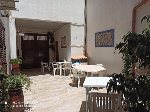 a patio with tables and chairs in a building at B&B Da Matì in Campobello di Mazara