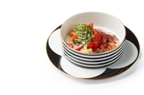 a bowl of food on a plate on a table at Casa Vissani in Baschi