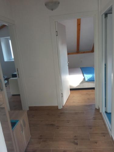 a room with a bedroom with a bed in it at Apartment Rosić in Perast