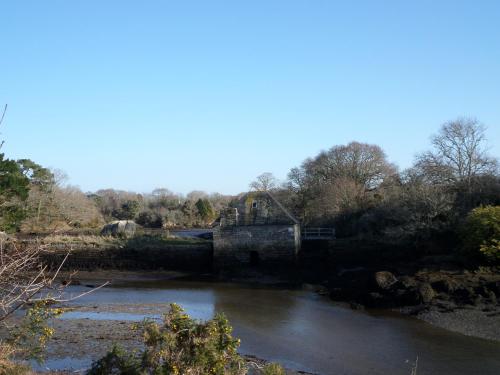 an old bridge over a river in a field at Hôtel Modern in Concarneau