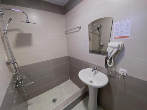 a bathroom with a sink and a shower at Geo Inn in Stepantsminda