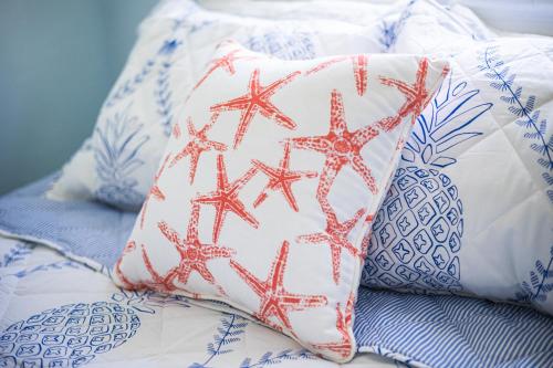a couple of pillows on a bed next to at Windward at the Beach in Beach Haven