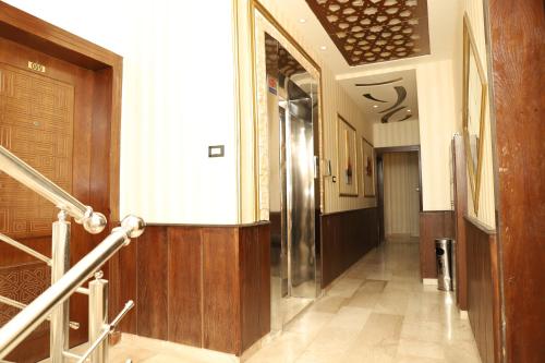 a hallway of a building with a door and stairs at AlQimah Hotel Apartments in Amman