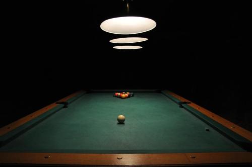 a pool table with a ball on top of it at Restauracja - Hotel Pałacowa in Rogowo