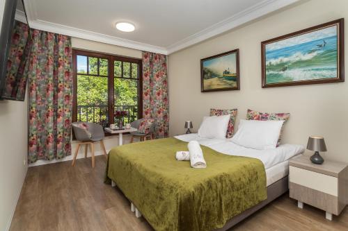 a bedroom with a bed and a desk and a window at Zamorski BY THE SEA in Sopot
