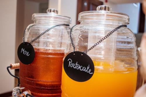 two mason jars filled with different types of honey at RIVER Hotel & SPA in Călimăneşti
