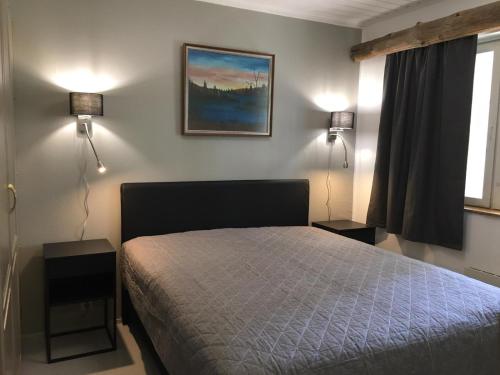 a bedroom with a bed with two lamps on it at Rukanaapa in Ruka