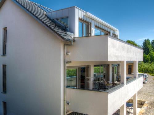 an external view of a white house with large windows at Alpenblick 2 in Lindau-Bodolz