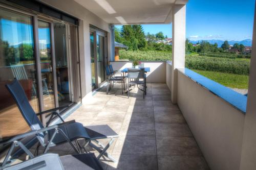 a balcony of a house with chairs and a table at Alpenblick 2 in Lindau-Bodolz
