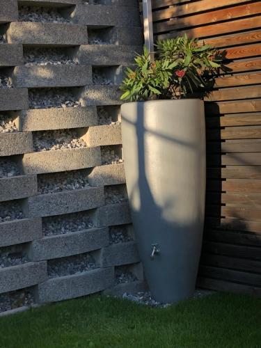 a large planter sitting next to a brick wall at Ferienwohnung Gritsch Sommercard inclusive in Jerzens