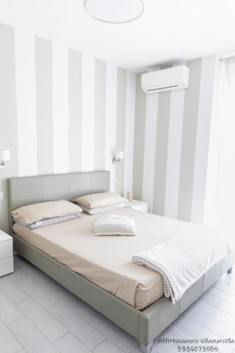 a white bedroom with a large bed in a room at Affittacamere Villa Marcella in La Spezia