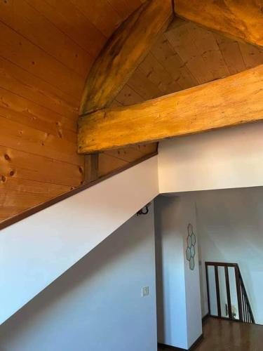 a wooden ceiling in a room with a staircase at Villa Berghinz in Venice-Lido