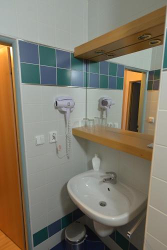 a bathroom with a sink and a mirror at Hotel Laguna & restaurant in České Budějovice