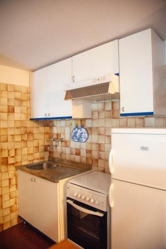 a small kitchen with white cabinets and a sink at loft sul mare Sirolo in Sirolo