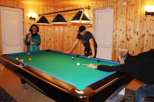 a group of people playing pool in a room at Guest House "Oasis" in Khulo