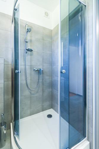 a shower with a glass door in a bathroom at Cisna Apartament in Cisna