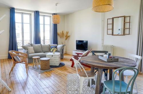 a living room with a couch and a table at Résidence L'Aristide : Appartement Malo in Auray