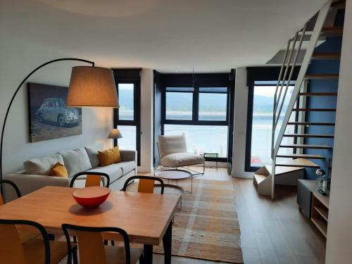 a living room with a couch and a table at Apartamentos Casa La Rambla in San Esteban de Pravia