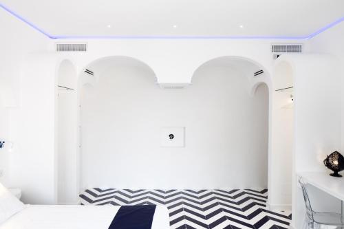 a bedroom with a black and white checkered floor at Positamy in Positano