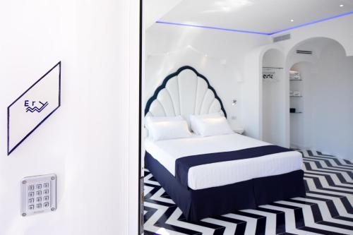 a bedroom with a bed with a black and white carpet at Positamy in Positano
