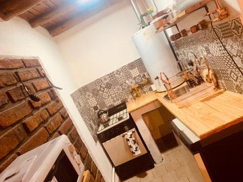 a kitchen with a counter and a stove top oven at Bungalows Luz del sur in San Carlos de Bariloche