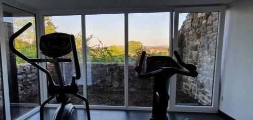 a gym with two exercise bikes in front of a window at Casas de Campo da Barroca in Tabosa