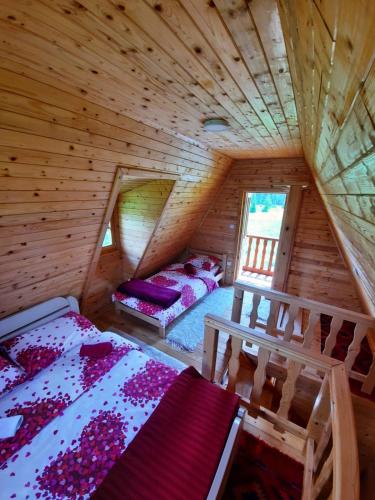 a room with two beds in a wooden cabin at Holiday Home Jabucilo in Žabljak