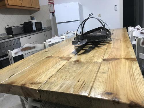a wooden table with a bag on top of it at Casa da Aldeia in Tomar
