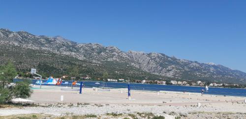 a volleyball court in front of a mountain at Apartment Ante and Dijana in Starigrad-Paklenica