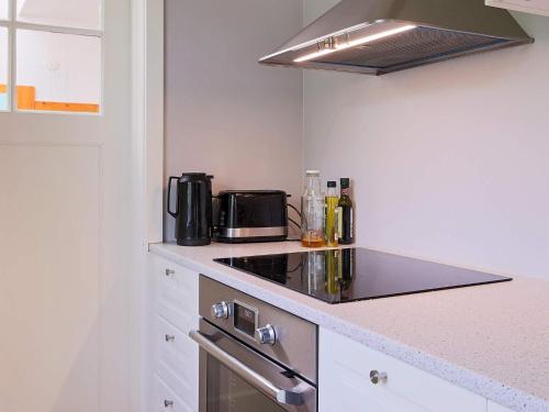 a kitchen with a stove and a counter top at 6 person holiday home in Gilleleje in Gilleleje