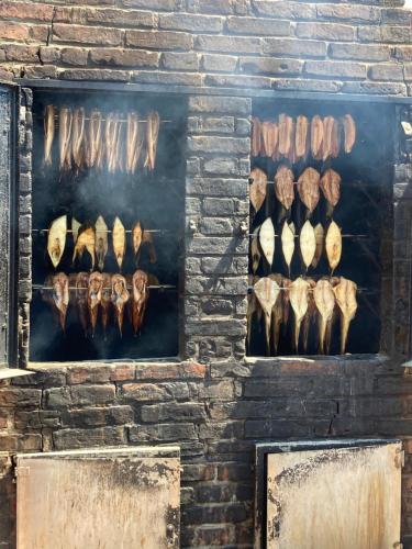a brick wall with a display of meat and bones at Apartamenty Planeta Mielno in Mielno
