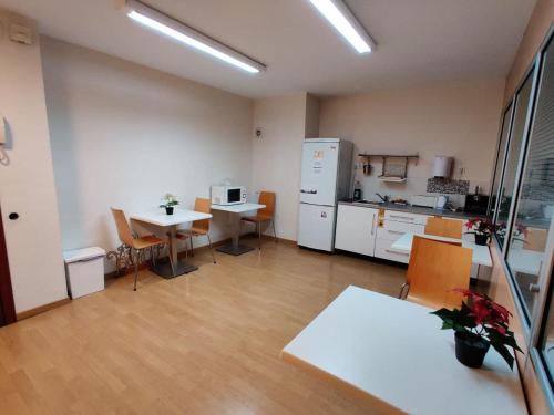 a large room with a kitchen and a table and chairs at Guest House Barcelona Bruc in Barcelona