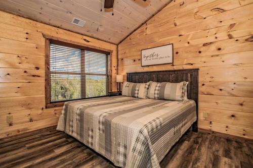 a bedroom with a bed in a log cabin at Shelter Me - 5 Miles to Dollywood , Hot Tub, Wi-Fi, Game Room in Pigeon Forge