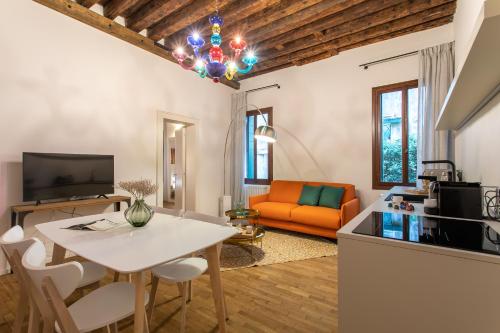 a living room with a white table and a couch at Palazzo Venere Apartments in Venice