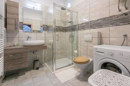 a bathroom with a shower toilet and a sink at House TINAC in Crikvenica