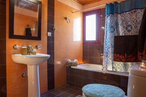 a bathroom with a sink and a bath tub at Maria's House in Nydri
