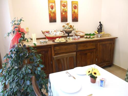 a room with a counter with food on it at Albergo La Casa Nel Bosco in Col Sant'Angelo
