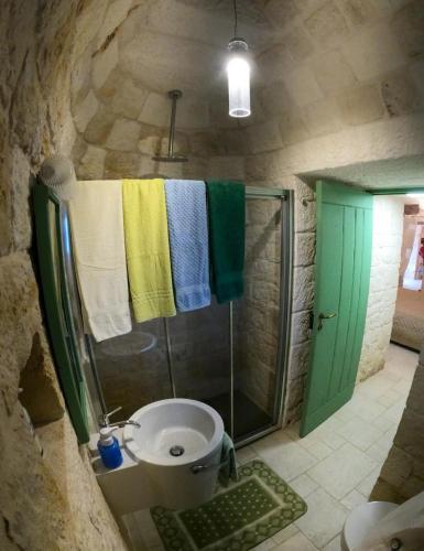 a bathroom with a shower and a toilet and a sink at Trullo Nadia Ostuni in Ostuni